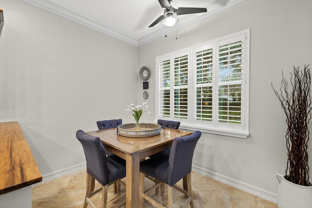 dining room with crown molding and ceiling fan