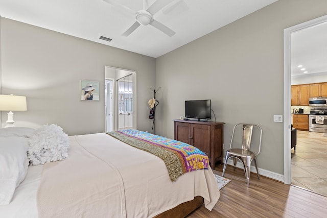 bedroom featuring ceiling fan, connected bathroom, and hardwood / wood-style floors