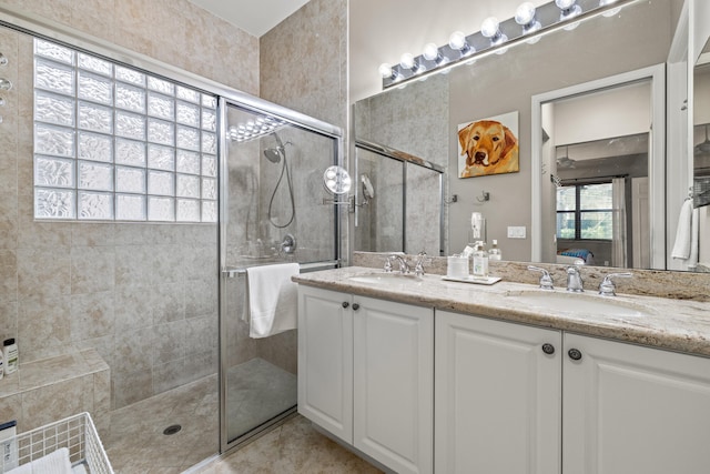 bathroom featuring walk in shower and vanity