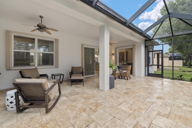 sunroom with ceiling fan and a wealth of natural light