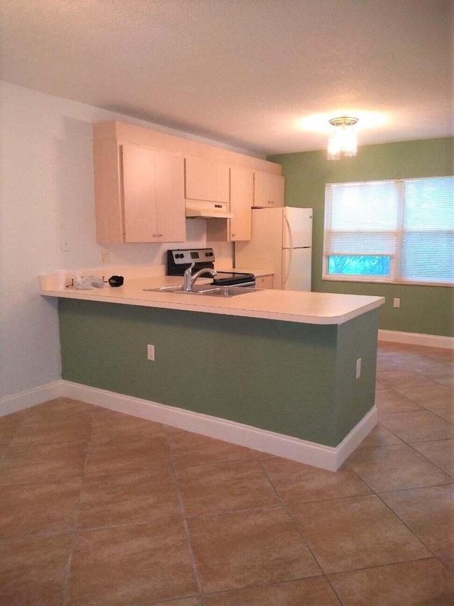 kitchen with tile patterned flooring, kitchen peninsula, stainless steel electric range oven, white cabinets, and white refrigerator