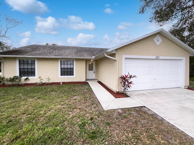 single story home with a garage and a front lawn