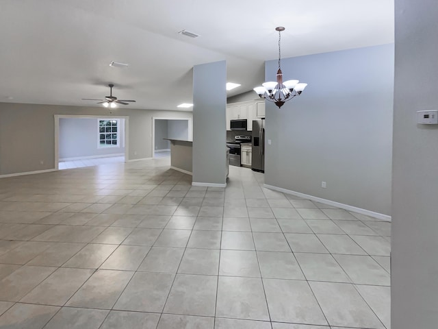 interior space with ceiling fan with notable chandelier, vaulted ceiling, and light tile patterned flooring