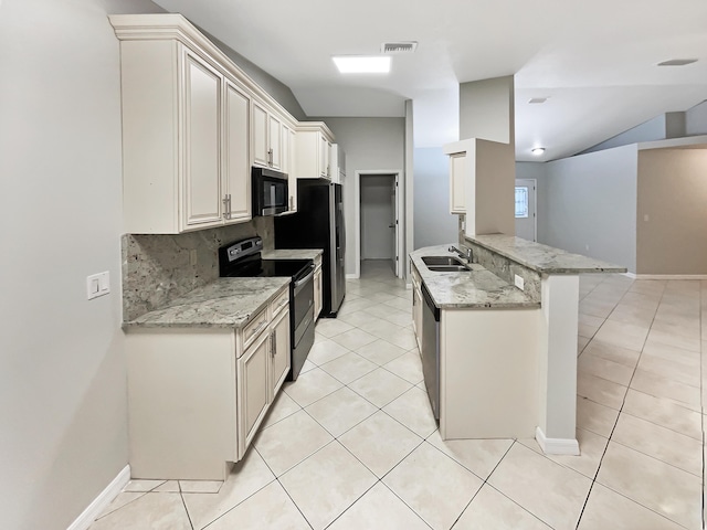 kitchen featuring sink, light stone counters, appliances with stainless steel finishes, and decorative backsplash