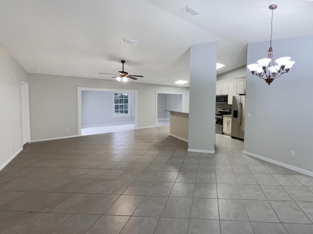 unfurnished living room with ceiling fan with notable chandelier, light tile patterned floors, and lofted ceiling