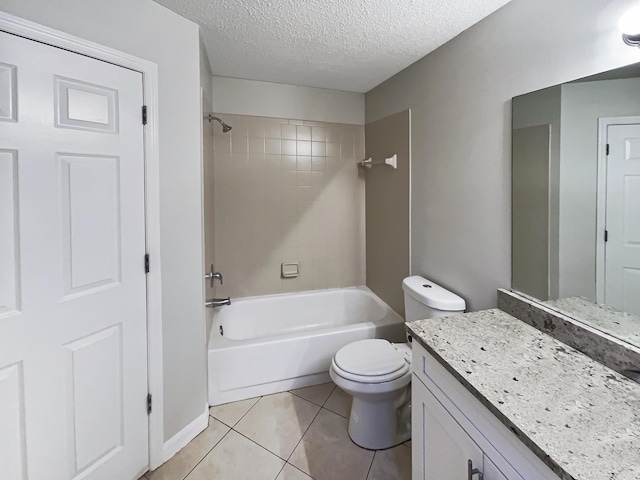 full bathroom featuring toilet, a textured ceiling, tiled shower / bath combo, tile patterned flooring, and vanity