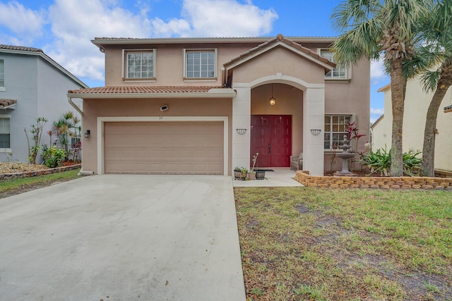 mediterranean / spanish-style house with a front lawn and a garage