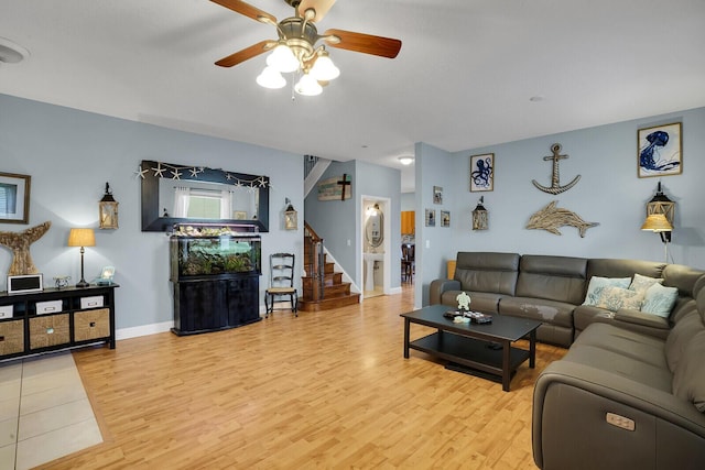 living room with light hardwood / wood-style flooring and ceiling fan