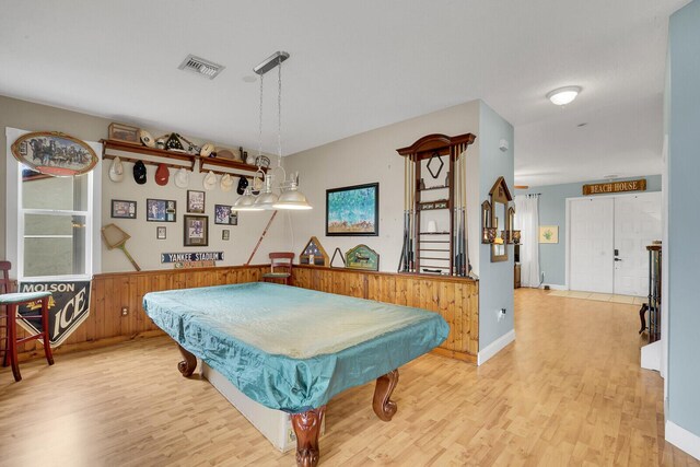 rec room with hardwood / wood-style floors, wooden walls, and billiards