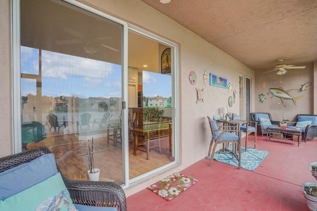 sunroom featuring ceiling fan