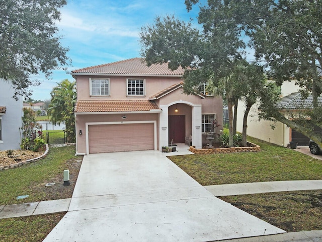 mediterranean / spanish-style home featuring a garage and a front yard