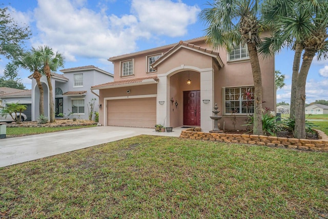 mediterranean / spanish house with a garage and a front yard