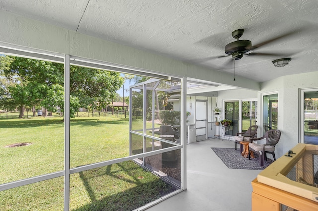 sunroom featuring ceiling fan