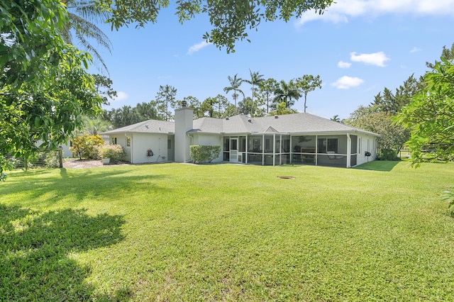 rear view of house featuring a yard