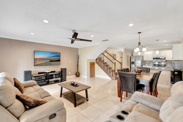 living room featuring light tile patterned floors, crown molding, and ceiling fan