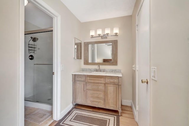 bathroom with vanity, hardwood / wood-style floors, and walk in shower