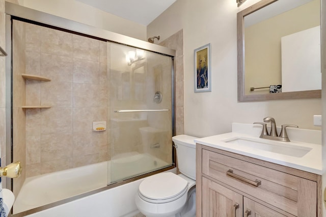 full bathroom featuring vanity, enclosed tub / shower combo, and toilet