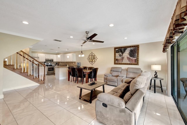 living room with crown molding, ceiling fan, and light tile patterned floors