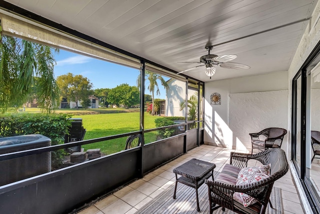 sunroom / solarium featuring ceiling fan