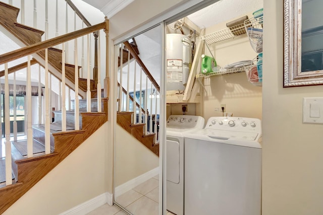 laundry room featuring gas water heater, washer and dryer, and light tile patterned flooring