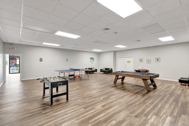 game room featuring hardwood / wood-style floors and a paneled ceiling