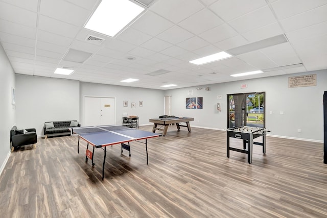 rec room with wood-type flooring and a paneled ceiling