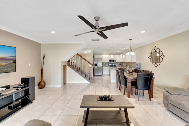 tiled living room featuring ornamental molding and ceiling fan