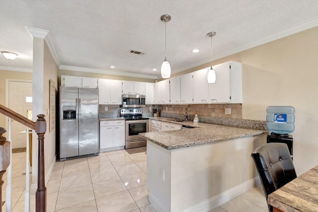 kitchen featuring white cabinetry, decorative light fixtures, decorative backsplash, and appliances with stainless steel finishes