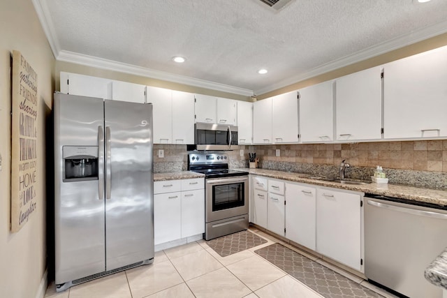 kitchen featuring stainless steel appliances, white cabinetry, sink, and crown molding