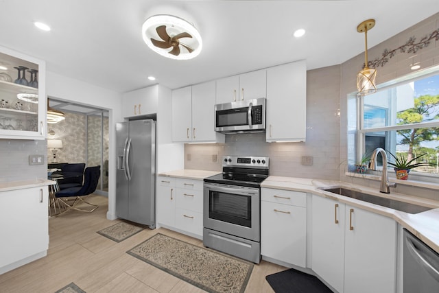 kitchen featuring white cabinets, appliances with stainless steel finishes, and sink