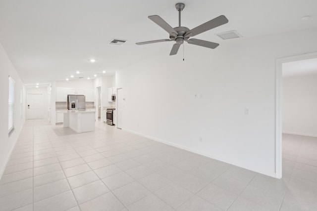 unfurnished living room with light tile patterned flooring and ceiling fan