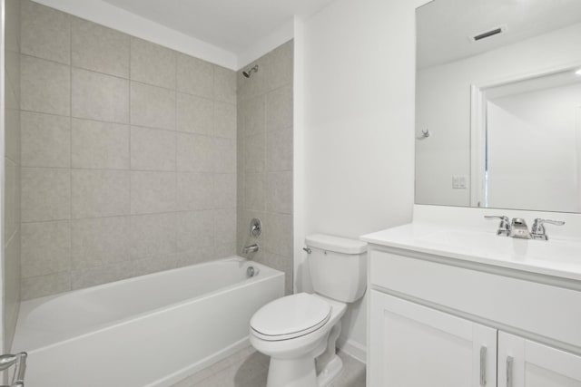 full bathroom with vanity, tiled shower / bath combo, tile patterned floors, and toilet