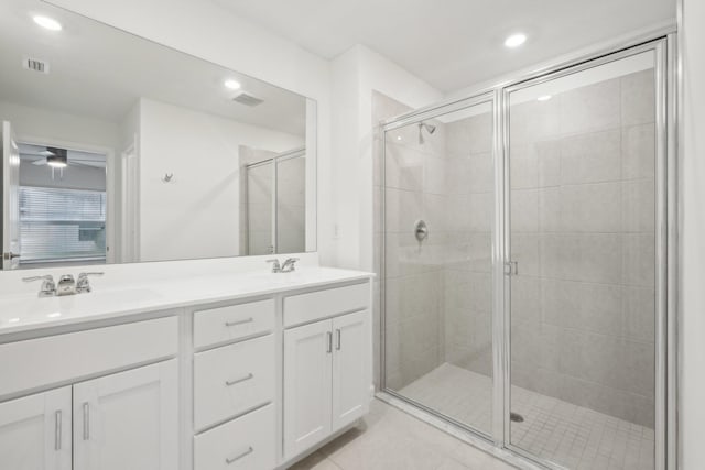 bathroom with tile patterned flooring, vanity, and a shower with shower door