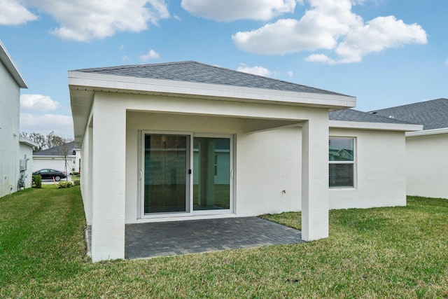 back of house featuring a yard and a patio area