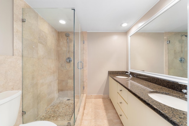 bathroom with tile patterned flooring, vanity, walk in shower, and toilet