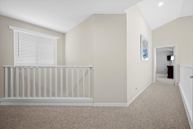 hall with carpet flooring and lofted ceiling