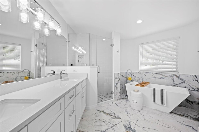 bathroom with independent shower and bath, tile walls, and vanity