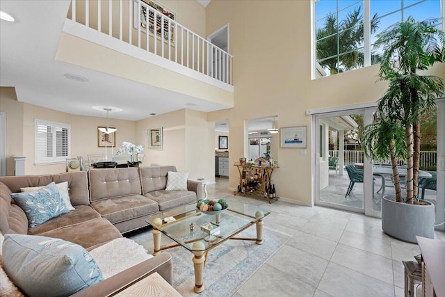 living room featuring light tile patterned floors and a towering ceiling