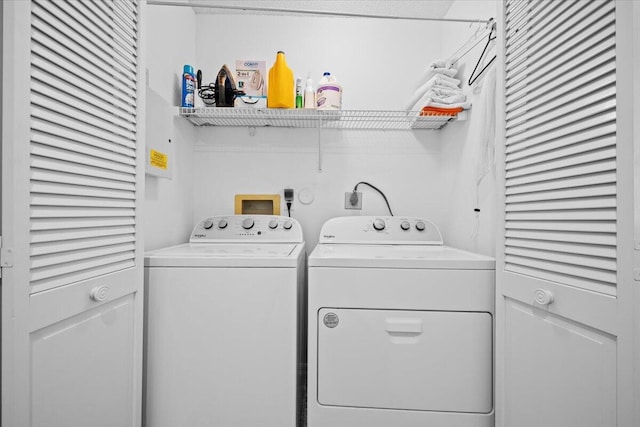 clothes washing area featuring washer and dryer