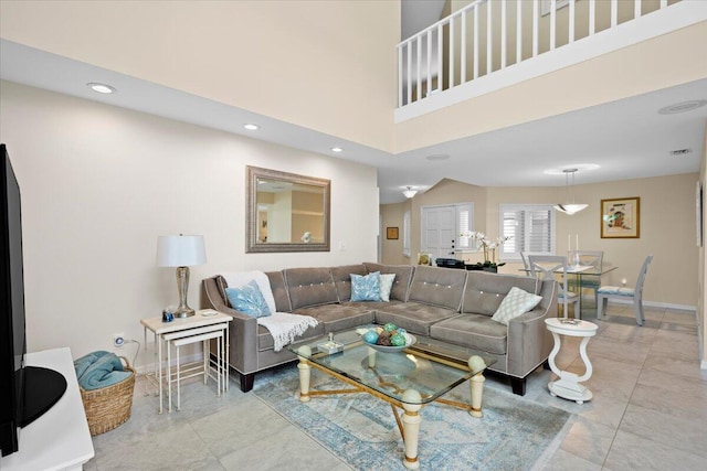 living room featuring a high ceiling and light tile patterned floors