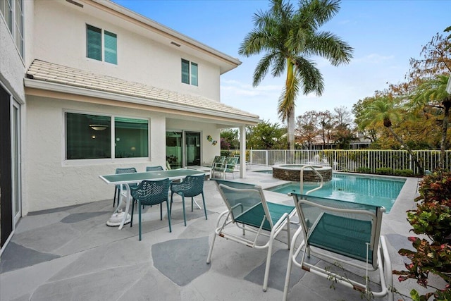 view of swimming pool featuring an in ground hot tub and a patio area