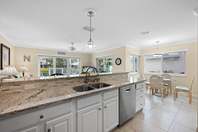 kitchen featuring sink, hanging light fixtures, white cabinets, and dishwasher