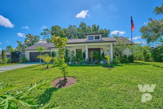 view of front of house featuring a garage and a front lawn