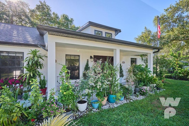 view of side of home featuring a yard and covered porch