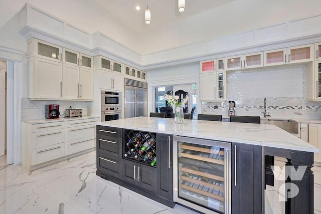 kitchen featuring pendant lighting, stainless steel appliances, wine cooler, tasteful backsplash, and a kitchen island