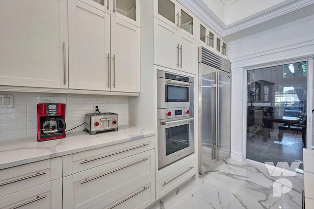 kitchen featuring white cabinetry, light stone countertops, and stainless steel appliances