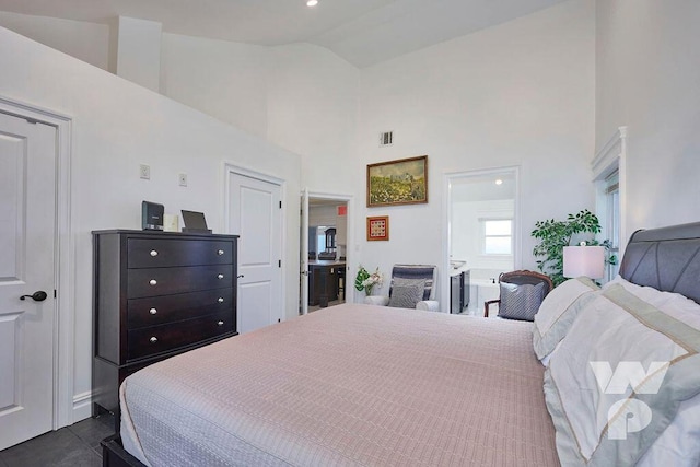 bedroom with high vaulted ceiling