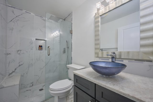 bathroom with vanity, toilet, and an enclosed shower