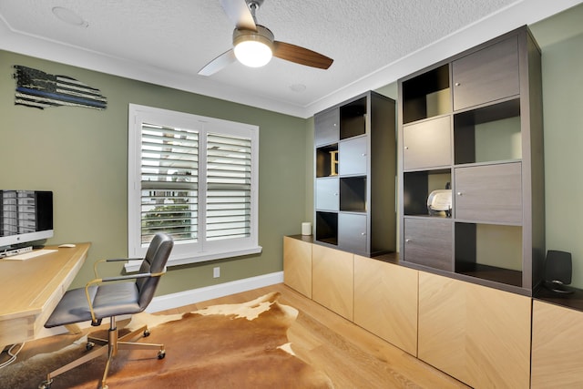 office with a textured ceiling, wood-type flooring, ornamental molding, and ceiling fan