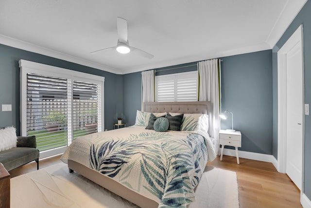 bedroom with hardwood / wood-style flooring, ornamental molding, and ceiling fan